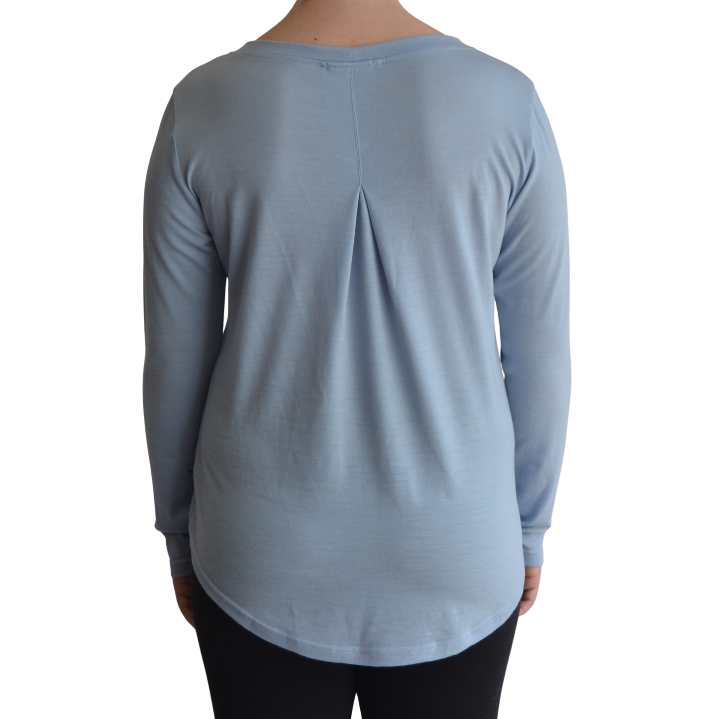 Links long sleeve merino top in ice blue colour, model faces away so the back is showing front on with a box pleat and scooped hemline.