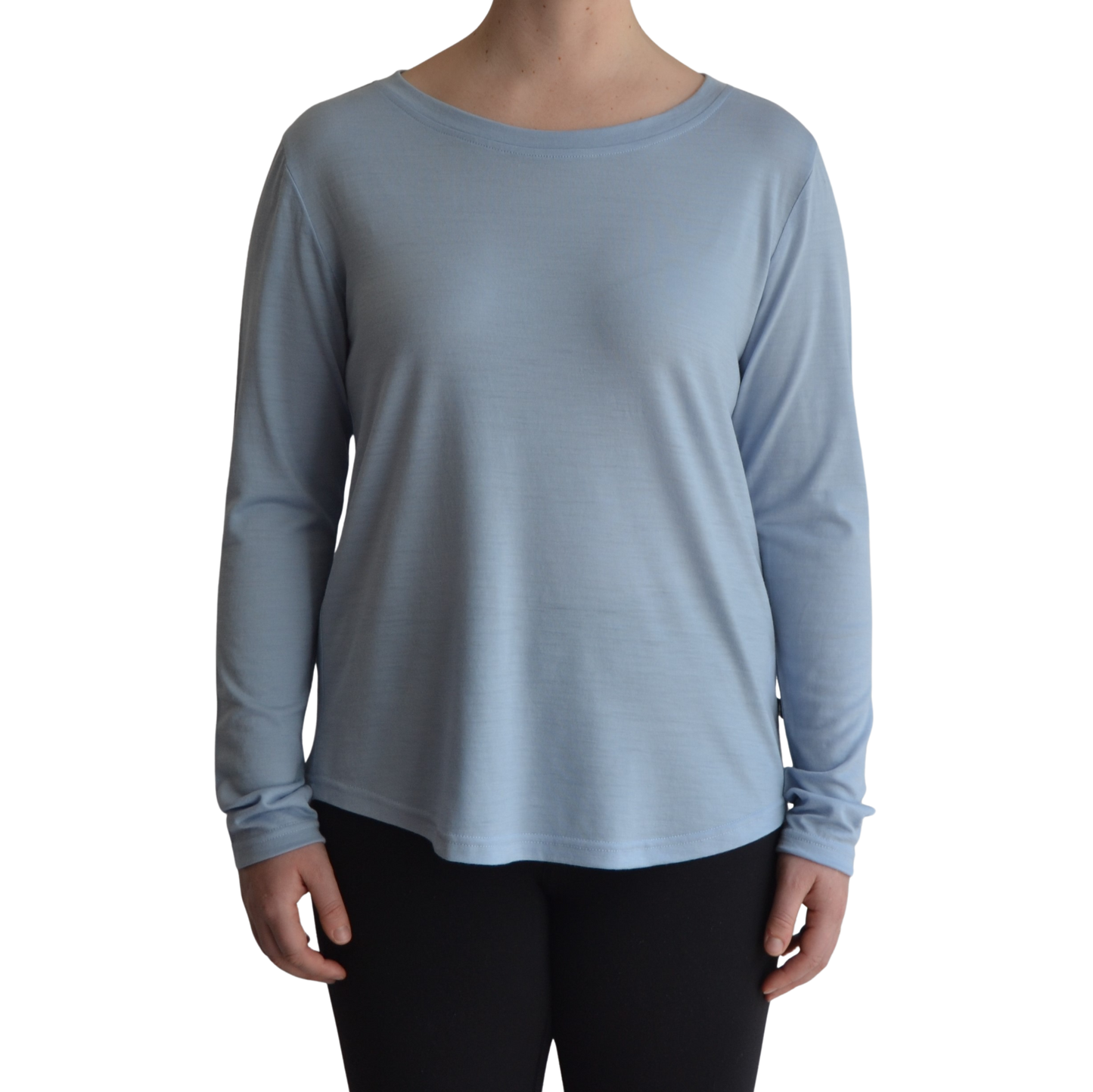 Links long sleeve merino top in ice blue colour, model faces forward showing the front of the top with scooped neck and hemline..