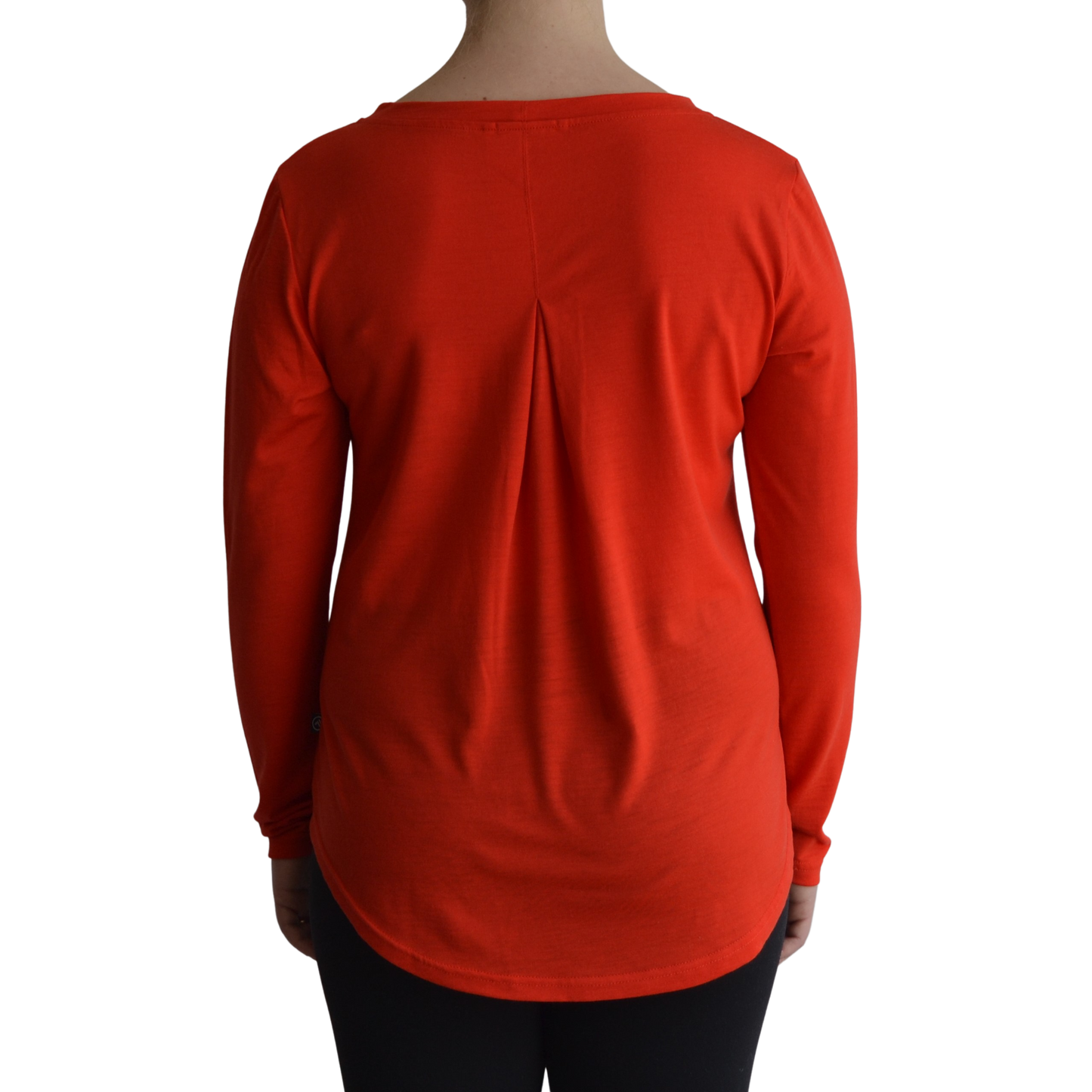 Links long sleeve merino top in mandarin colour, model faces away so the back is showing front on with a box pleat and scooped hemline.