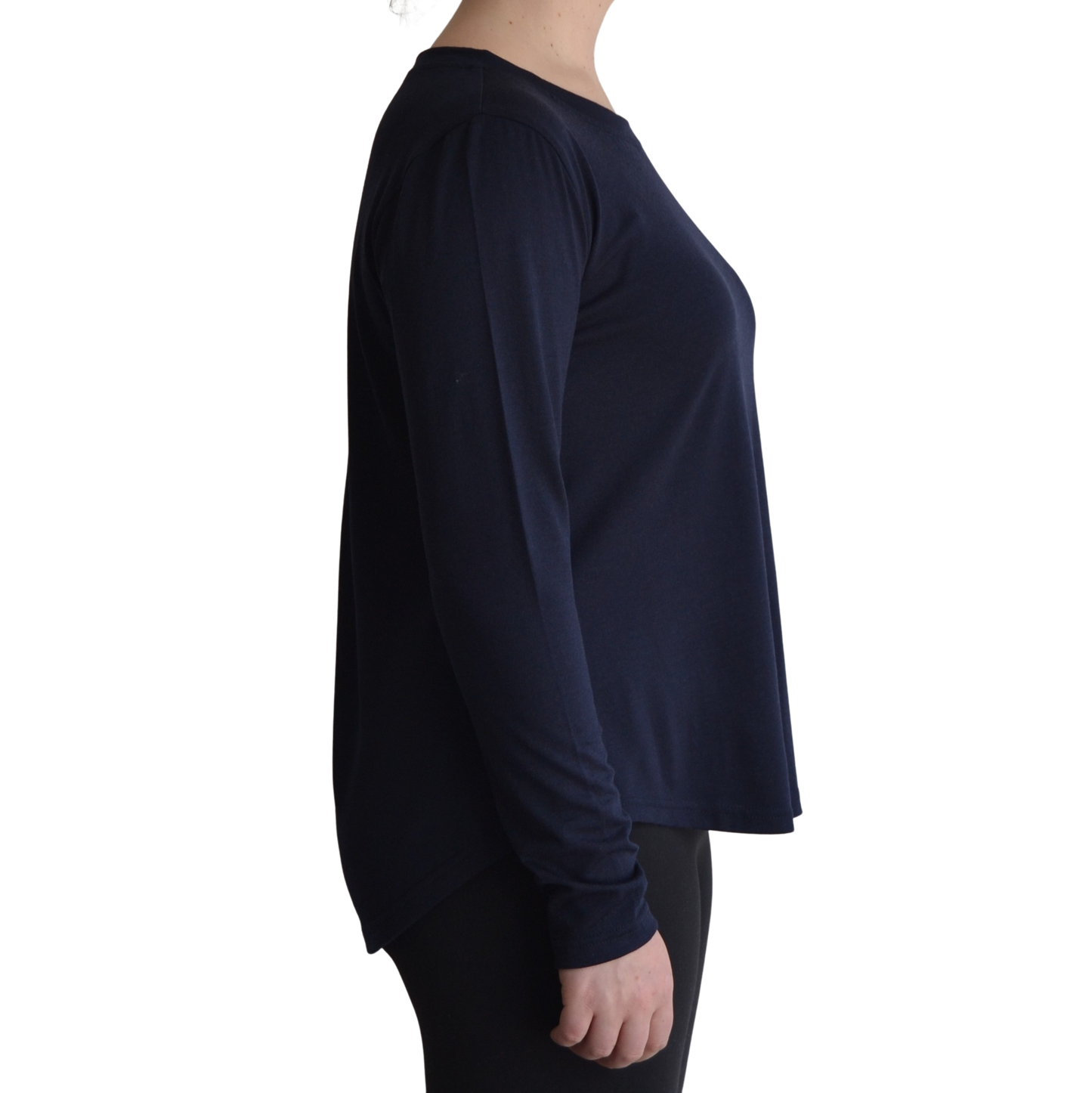 Links long sleeve merino top in navy blue colour, model is standing in profile showing the side view of the shirt with a scooped hemline that drops lower at the back.