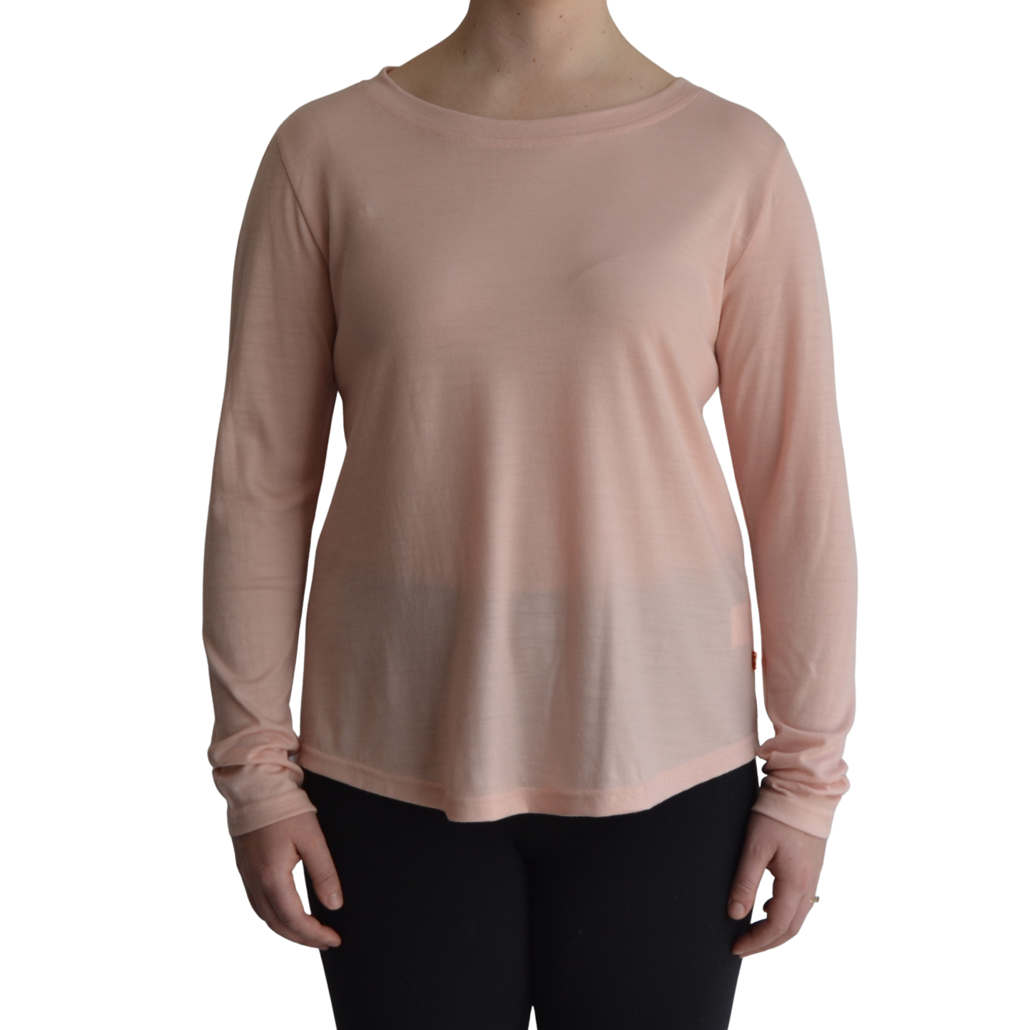 Links long sleeve merino top in petal light pink colour, model faces forward showing the front of the top with scooped neck and hemline..