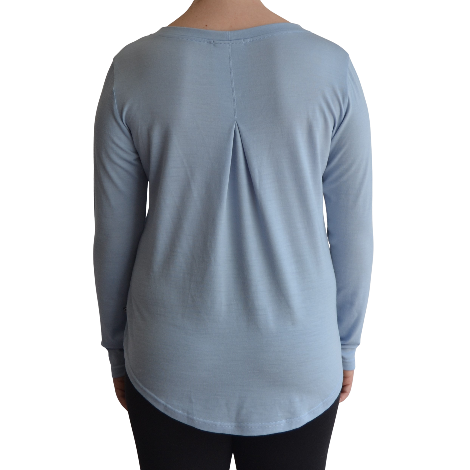 Links long sleeve merino top in ice blue colour, model faces away so the back is showing front on with a box pleat and scooped hemline. 