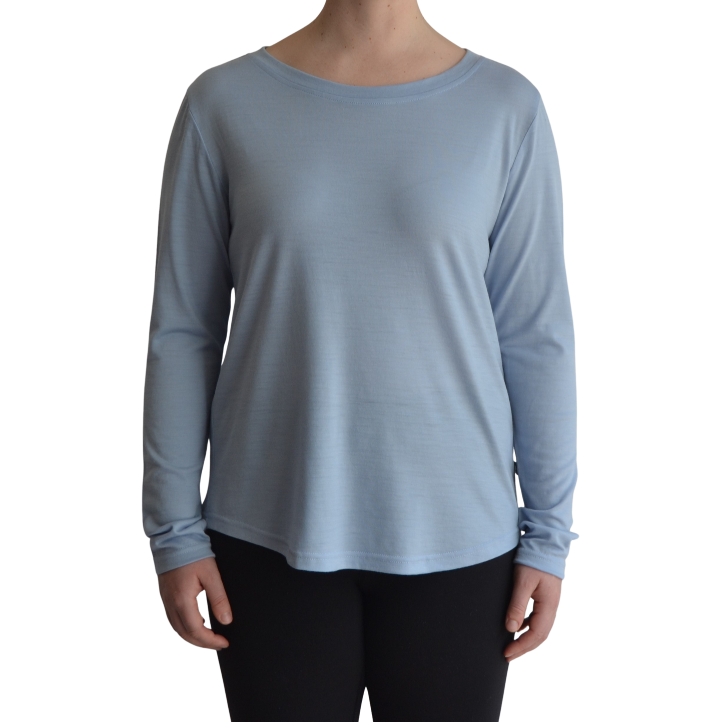 Links long sleeve merino top in ice blue colour, model faces forward showing the front of the top with scooped neck and hemline.. 
