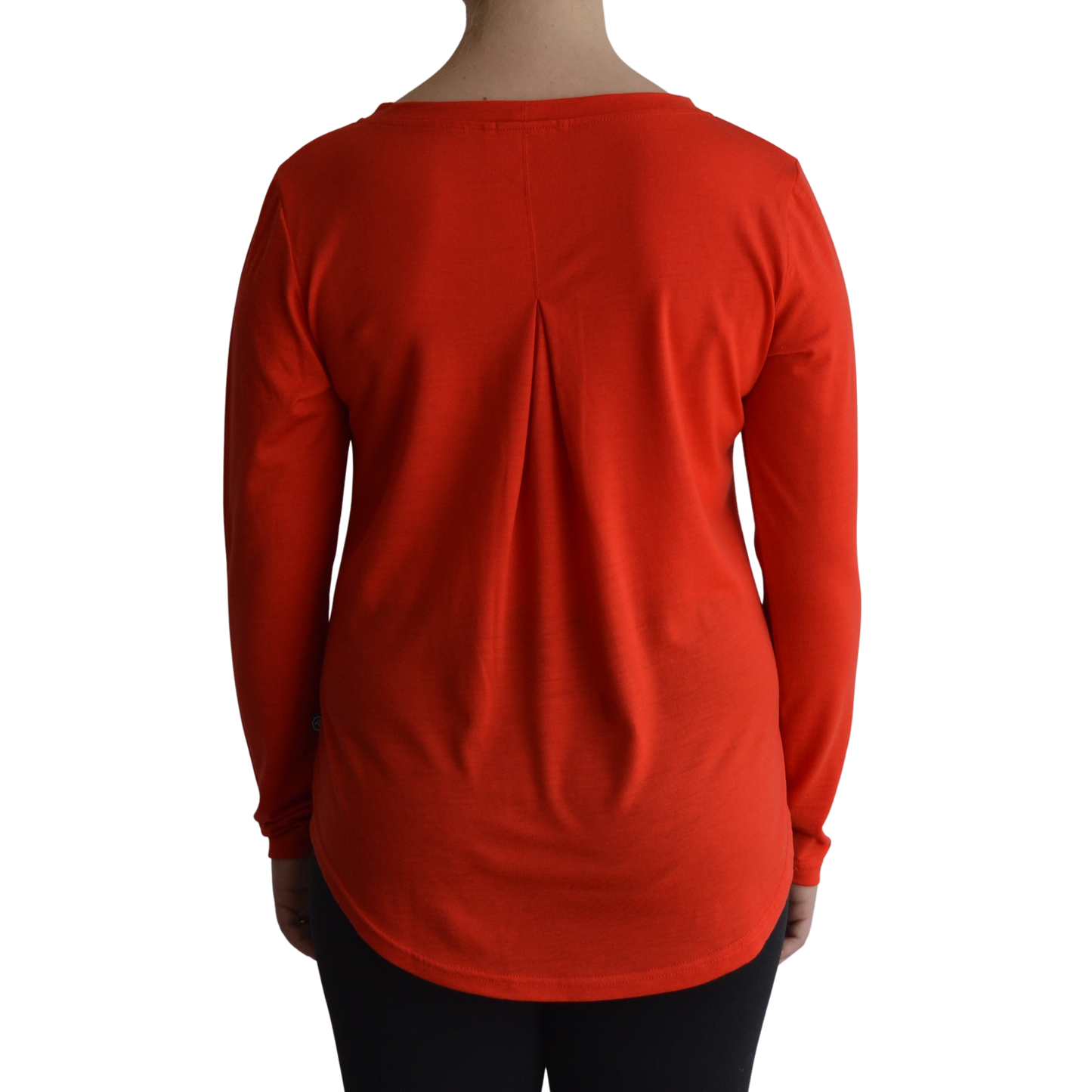 Links long sleeve merino top in mandarin colour, model faces away so the back is showing front on with a box pleat and scooped hemline. 