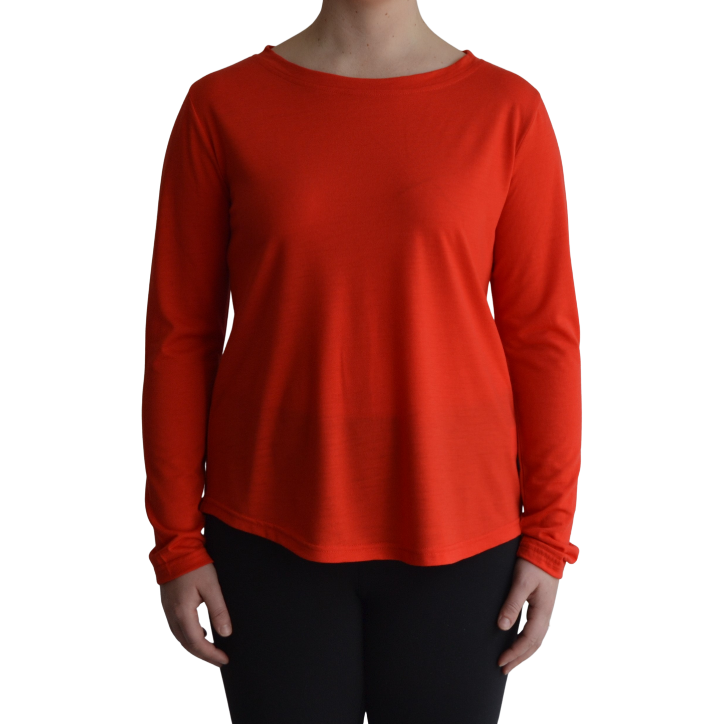 Links long sleeve merino top in mandarin colour, model faces forward showing the front of the top with scooped neck and hemline.. 