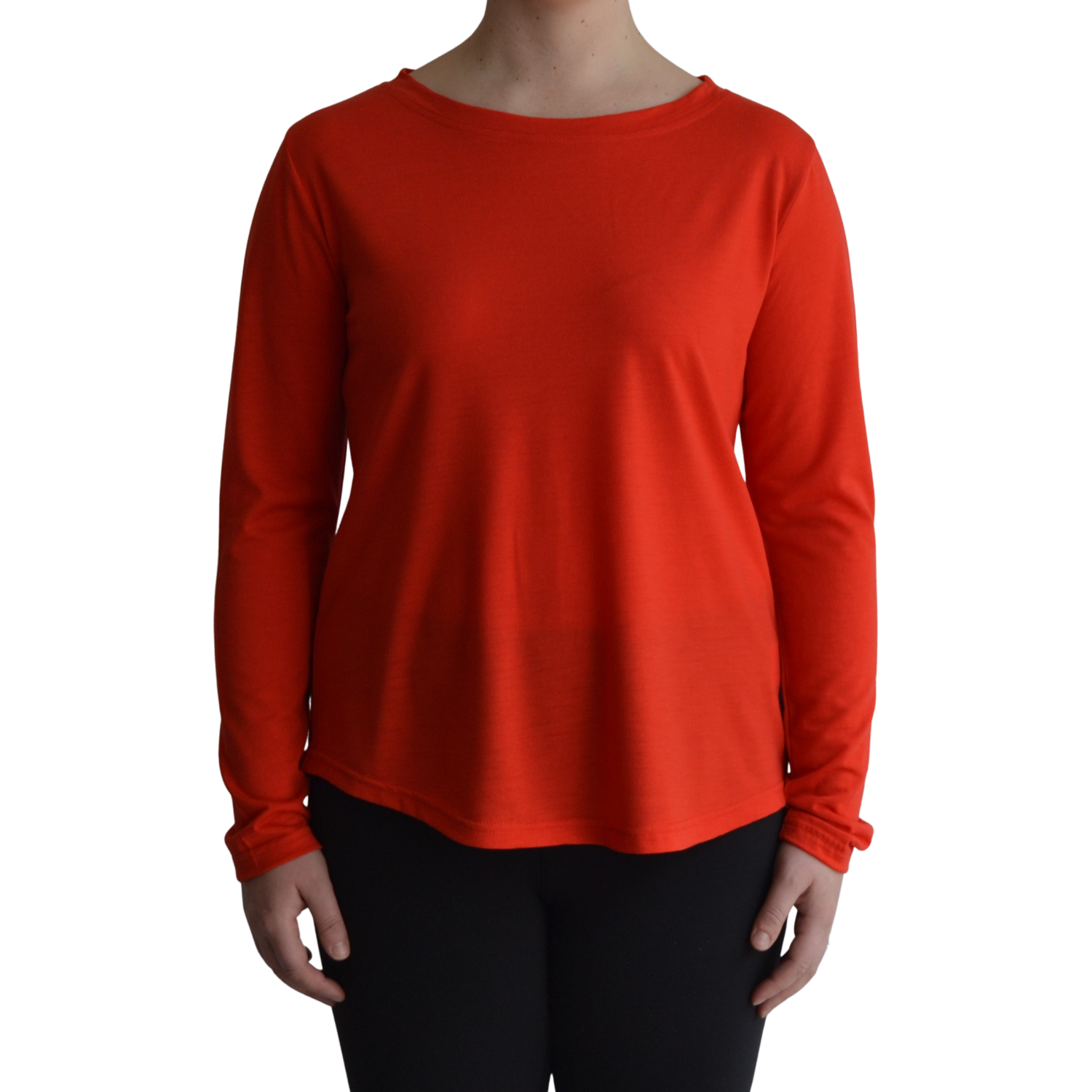 Links long sleeve merino top in mandarin colour, model faces forward showing the front of the top with scooped neck and hemline.. 
