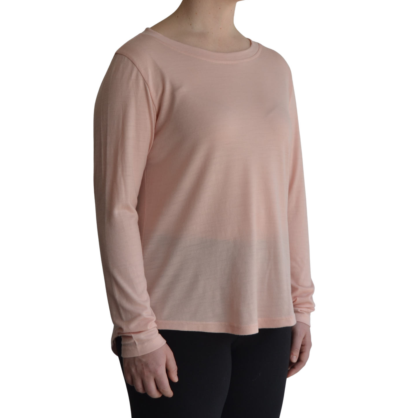 Links long sleeve merino top inpetal light pink colour. The model is standing on 45 degree angle facing forward