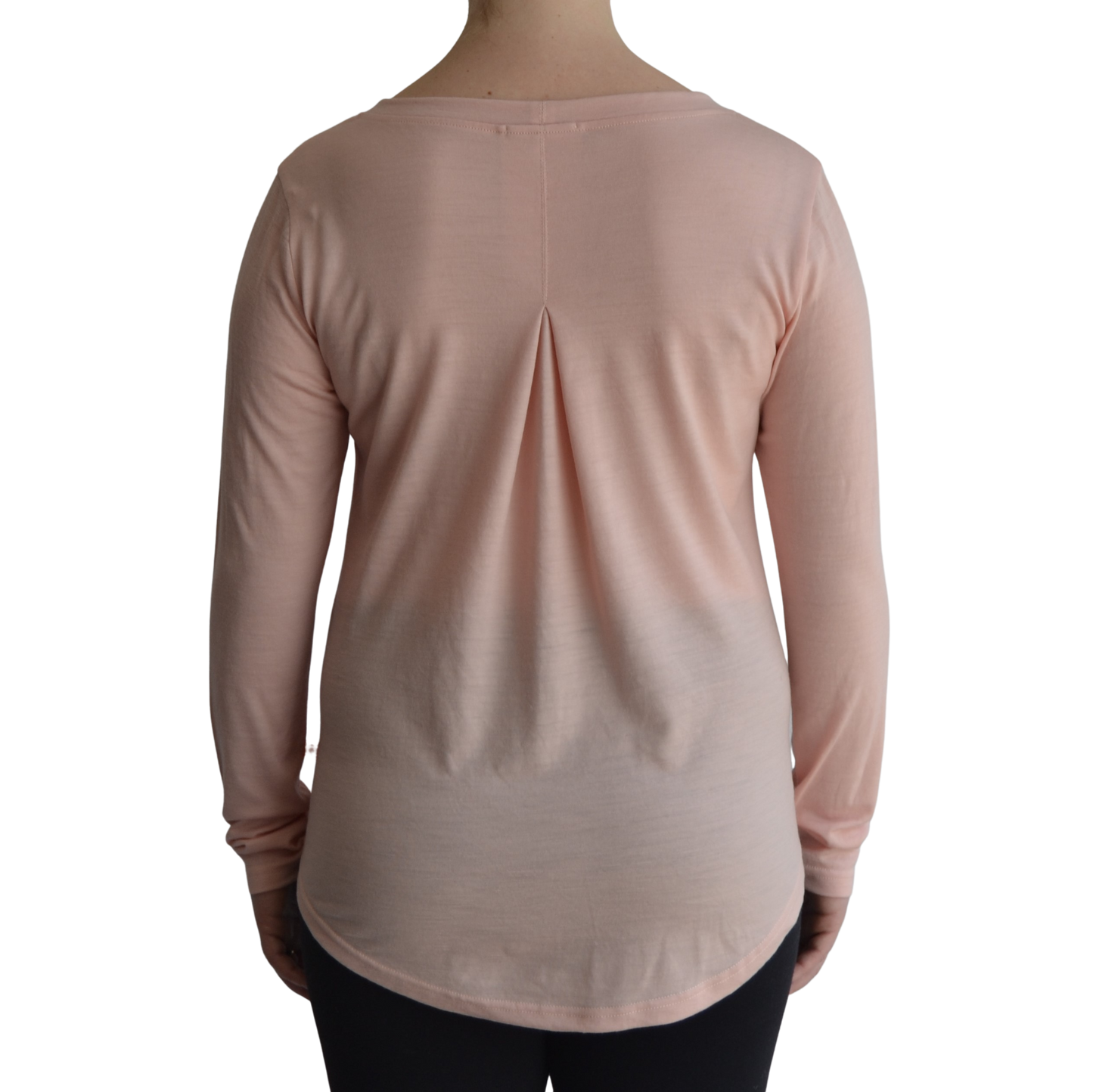 Links long sleeve merino top in petal light pink colour, model faces away so the back is showing front on with a box pleat and scooped hemline. 