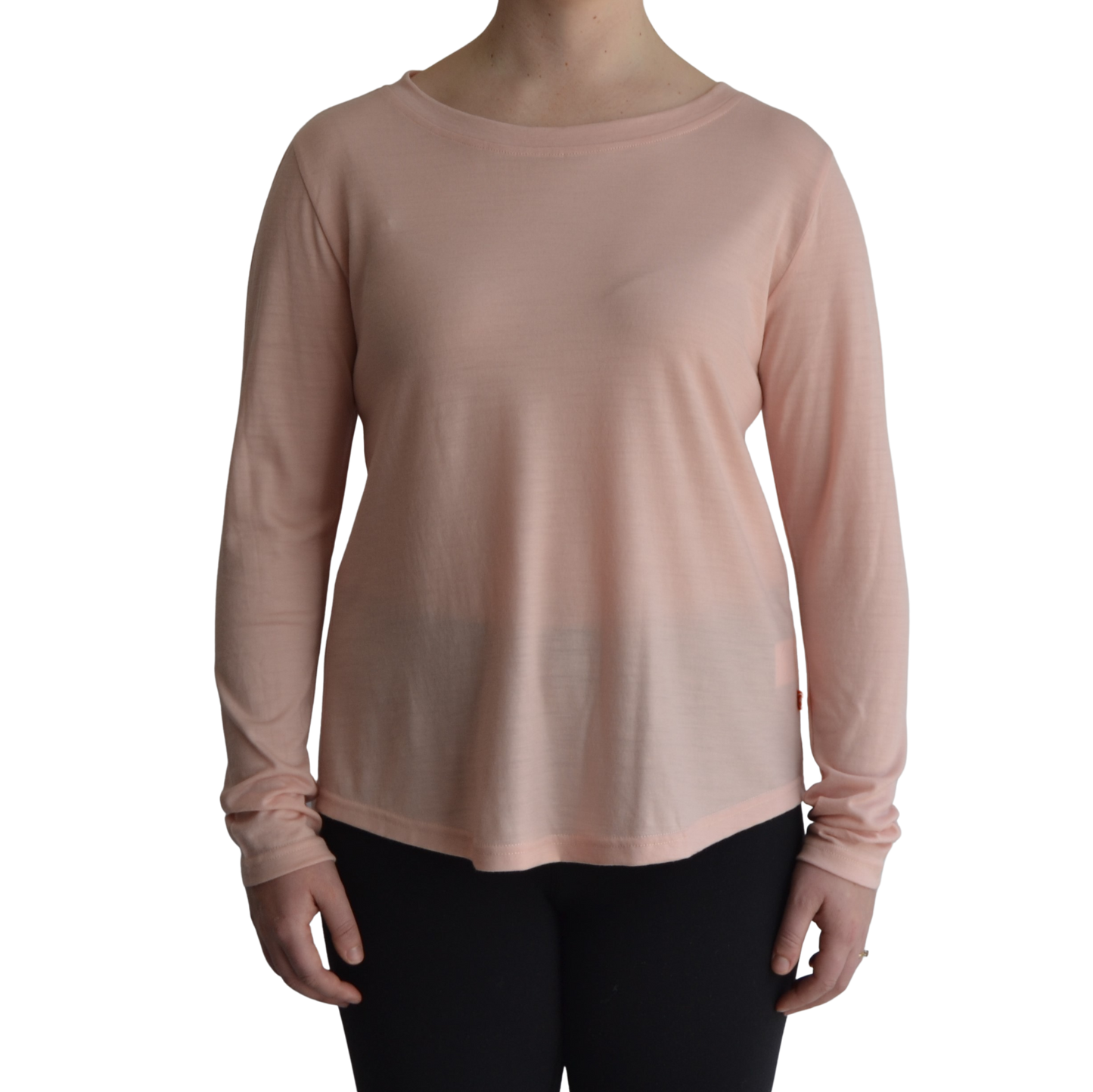 Links long sleeve merino top in petal light pink colour, model faces forward showing the front of the top with scooped neck and hemline.. 